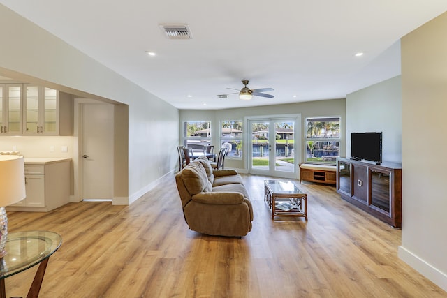 living area with recessed lighting, light wood-style flooring, and baseboards