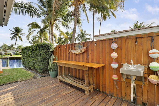 deck with a water view and a sink