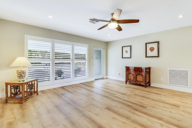 sitting room with baseboards, visible vents, ceiling fan, and wood finished floors