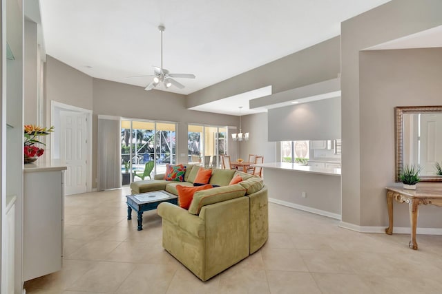 living room featuring light tile patterned floors, baseboards, vaulted ceiling, and ceiling fan with notable chandelier