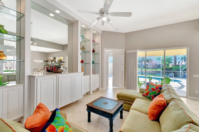 living area with light tile patterned floors, ceiling fan, built in shelves, and recessed lighting