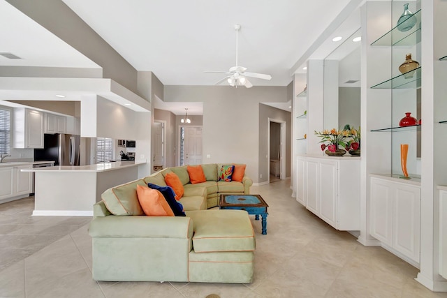 living room with ceiling fan, visible vents, and recessed lighting