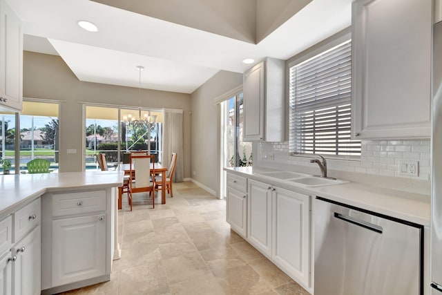 kitchen featuring a sink, white cabinets, light countertops, stainless steel dishwasher, and decorative backsplash