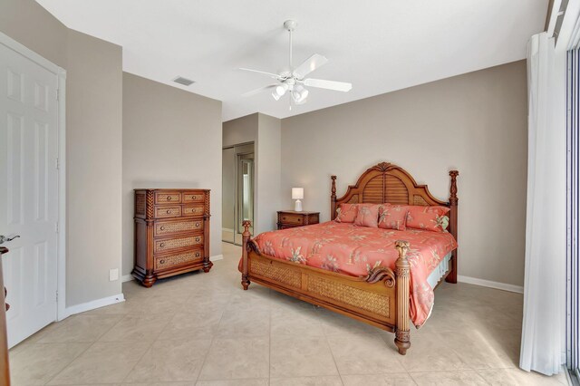 bedroom featuring a ceiling fan, visible vents, baseboards, and light tile patterned floors