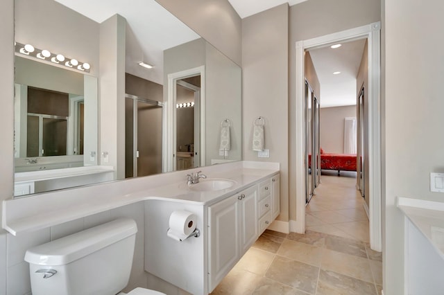 full bath featuring a stall shower, vanity, toilet, and recessed lighting