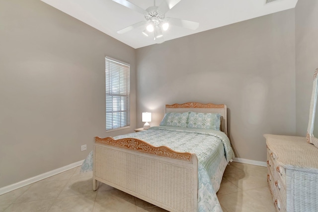 bedroom with light tile patterned flooring, a ceiling fan, and baseboards