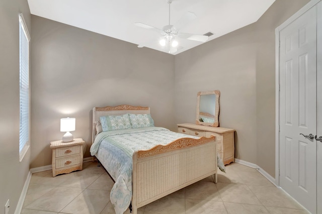 bedroom featuring light tile patterned floors, ceiling fan, and baseboards