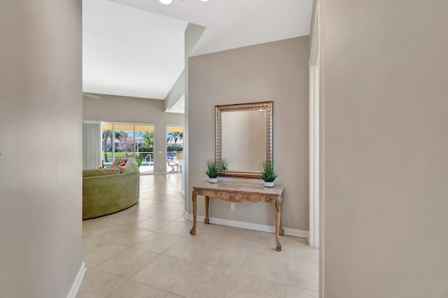 hall with light tile patterned floors and baseboards