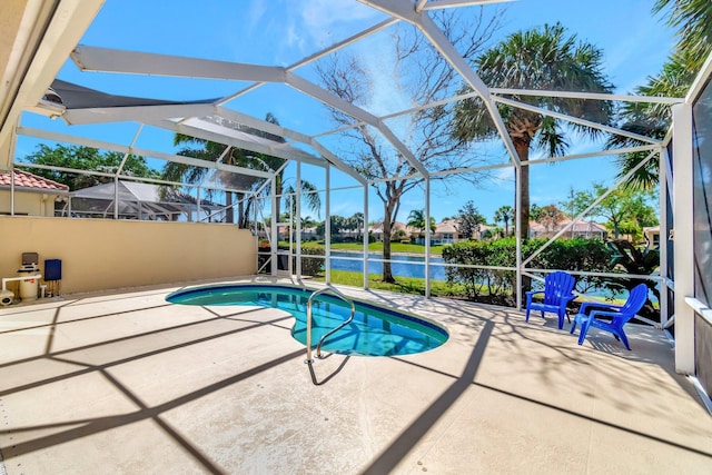 pool with glass enclosure and a patio area