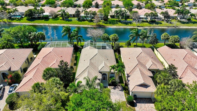 drone / aerial view with a residential view and a water view