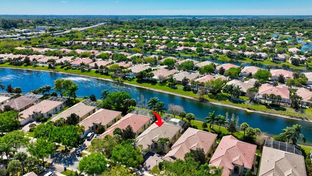 drone / aerial view with a water view and a residential view