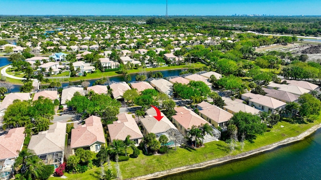 drone / aerial view with a water view and a residential view