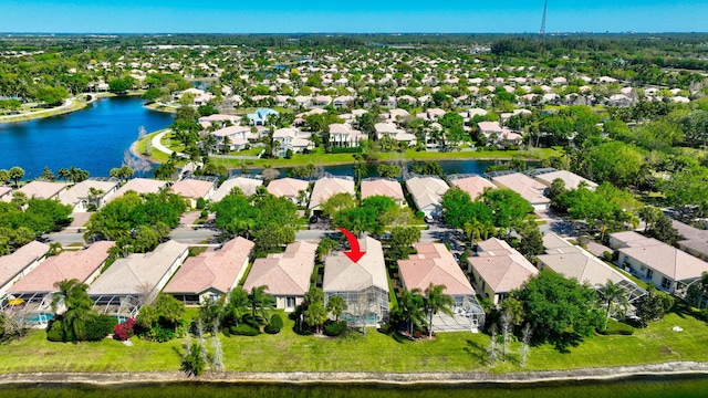 birds eye view of property featuring a water view and a residential view