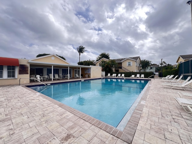 pool featuring a patio area and fence