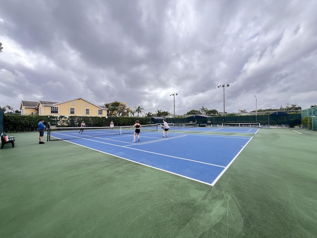 view of sport court featuring fence