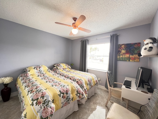 bedroom with ceiling fan, baseboards, a textured ceiling, and light colored carpet