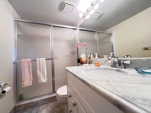 bathroom with toilet, a stall shower, visible vents, and vanity