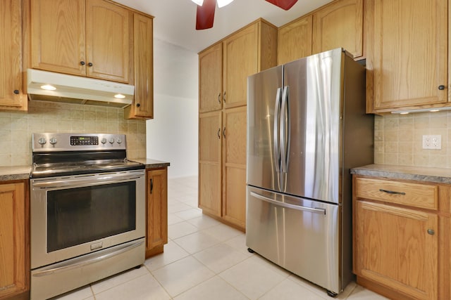 kitchen featuring light tile patterned floors, under cabinet range hood, a ceiling fan, appliances with stainless steel finishes, and backsplash