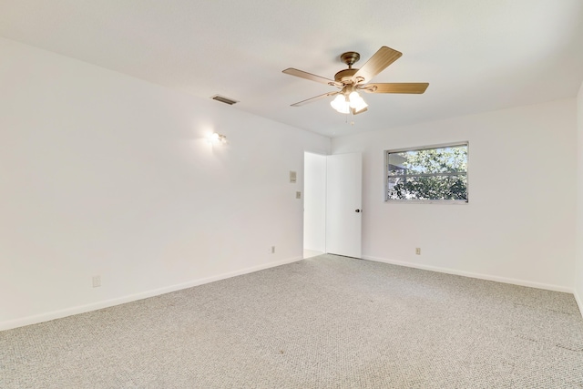 unfurnished room featuring a ceiling fan, carpet, visible vents, and baseboards