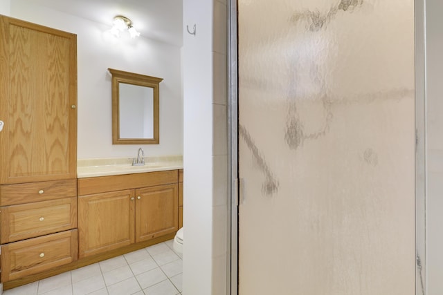 bathroom with vanity, a shower stall, toilet, and tile patterned floors