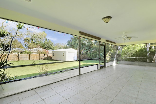 unfurnished sunroom with a ceiling fan