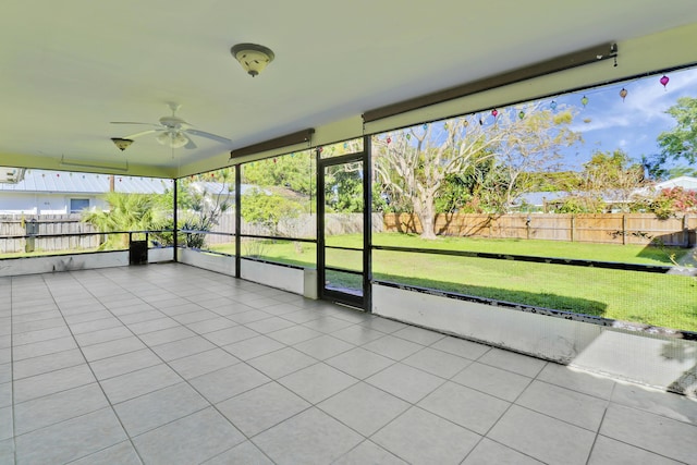 unfurnished sunroom featuring ceiling fan