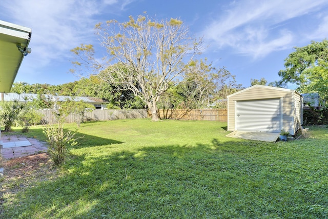 view of yard featuring a storage shed, an outdoor structure, and a fenced backyard