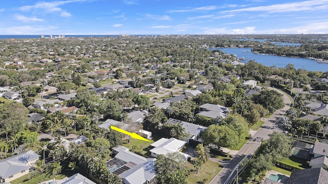 drone / aerial view featuring a residential view and a water view