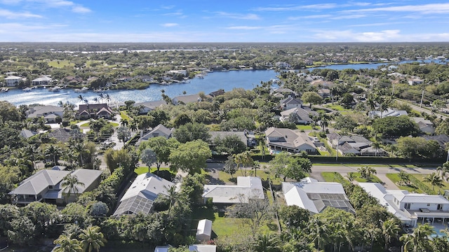 drone / aerial view featuring a water view and a residential view