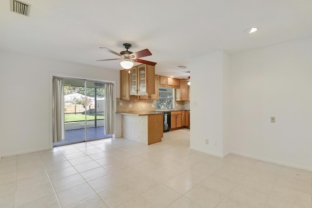 kitchen featuring black dishwasher, brown cabinets, tasteful backsplash, visible vents, and a peninsula