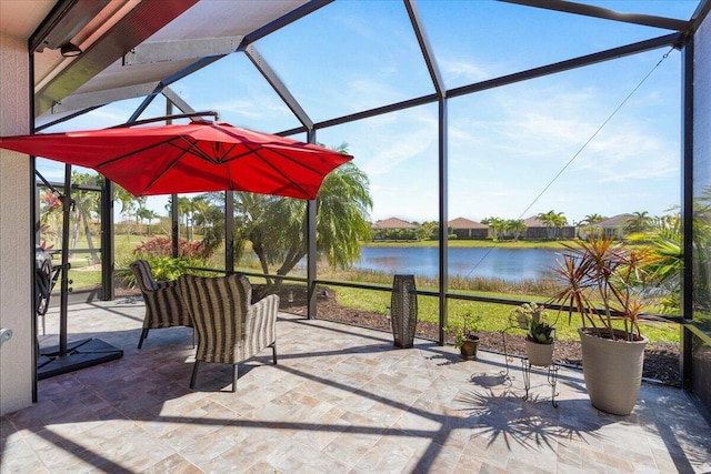 view of patio / terrace with a water view and glass enclosure