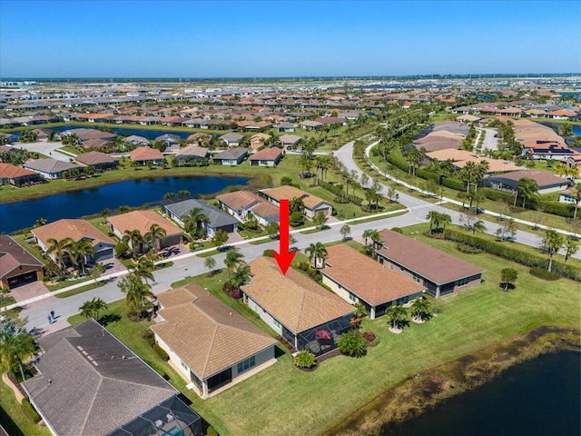 drone / aerial view featuring a water view and a residential view