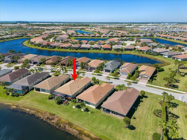 drone / aerial view featuring a residential view and a water view