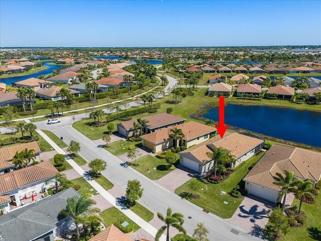 bird's eye view featuring a water view and a residential view