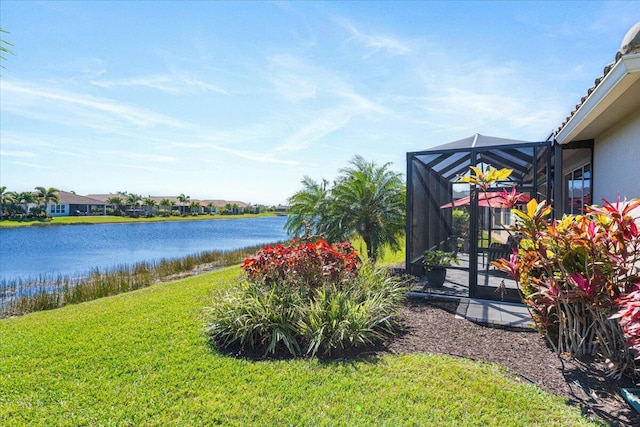 view of yard featuring a water view and glass enclosure