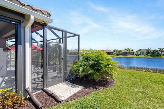 view of yard featuring a water view and a lanai