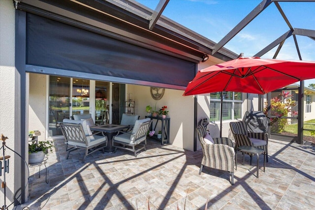 view of patio / terrace featuring a lanai