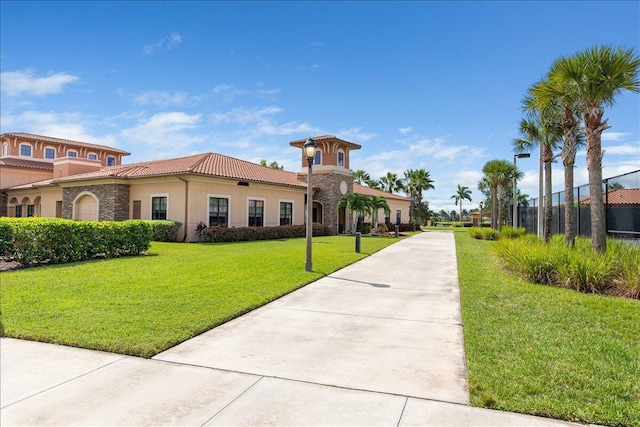 surrounding community with fence and a yard