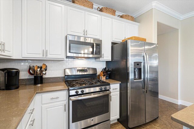 kitchen featuring white cabinetry, appliances with stainless steel finishes, tasteful backsplash, and crown molding