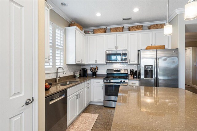 kitchen featuring stainless steel appliances, visible vents, a sink, and ornamental molding