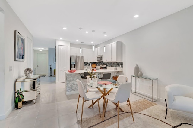 dining room with light tile patterned floors, recessed lighting, and baseboards