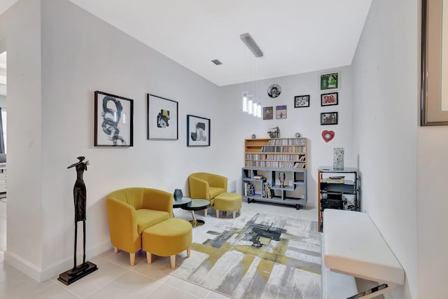 living area featuring visible vents, baseboards, and tile patterned flooring