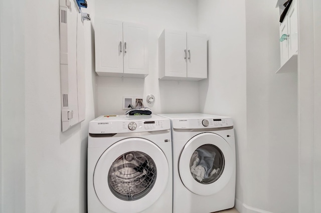 laundry area featuring cabinet space and washer and clothes dryer