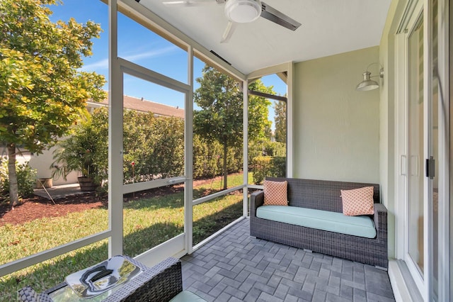 sunroom / solarium with a ceiling fan