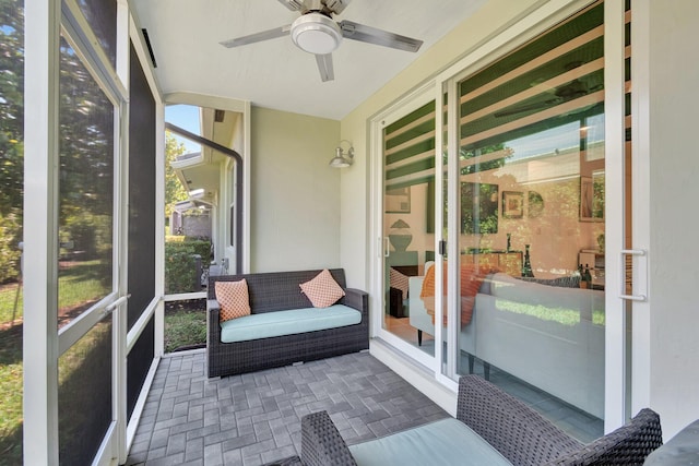 sunroom featuring ceiling fan