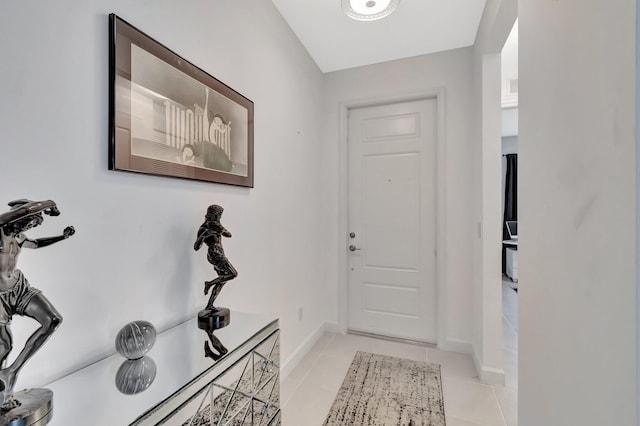 entryway featuring light tile patterned floors and baseboards