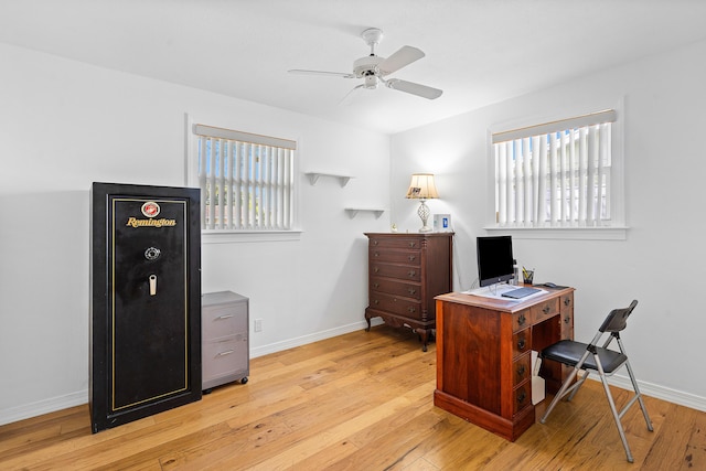 office space featuring light wood-type flooring, baseboards, and a ceiling fan