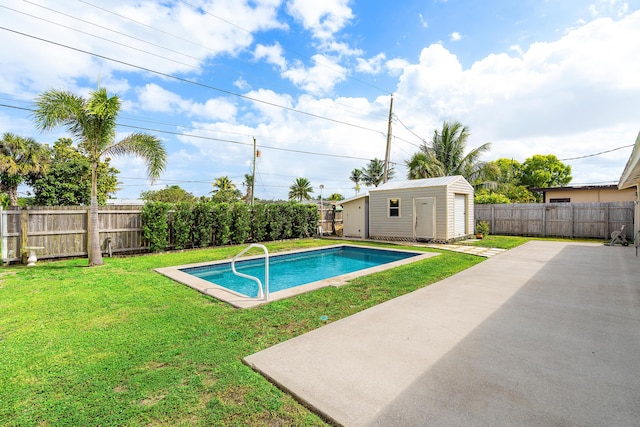 view of swimming pool featuring an outbuilding, a fenced backyard, a yard, a fenced in pool, and a patio area