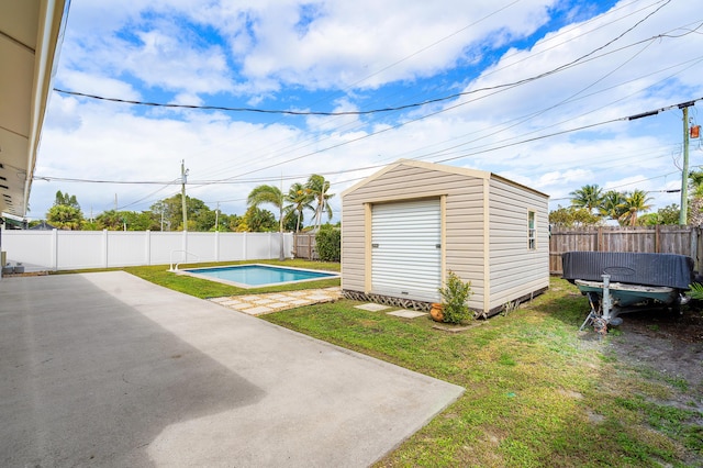 view of pool featuring a patio area, a fenced backyard, a fenced in pool, and an outdoor structure