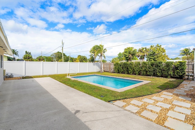 view of pool featuring a yard, a fenced backyard, and a patio